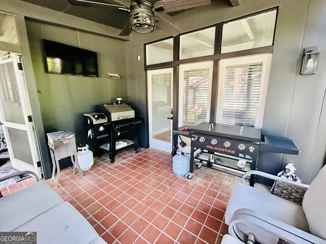 home office with tile flooring and ceiling fan