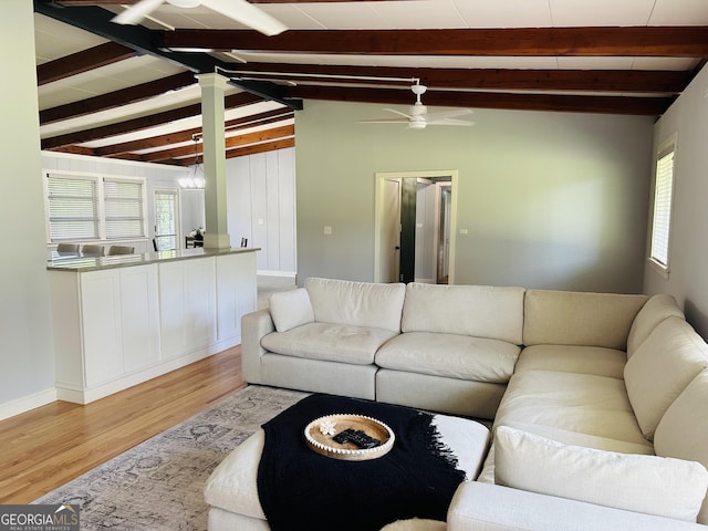 living room featuring lofted ceiling with beams, ceiling fan, and light hardwood / wood-style floors