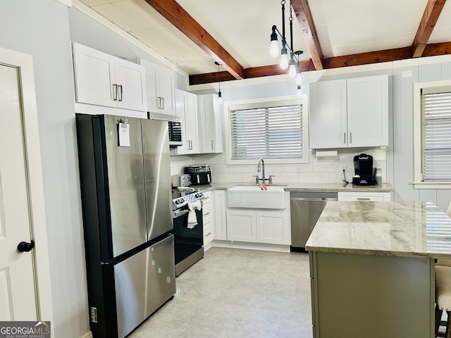 kitchen featuring white cabinetry, stainless steel appliances, sink, and beam ceiling