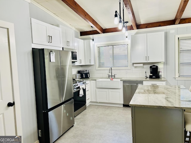 kitchen featuring sink, stainless steel appliances, beam ceiling, light stone countertops, and white cabinets