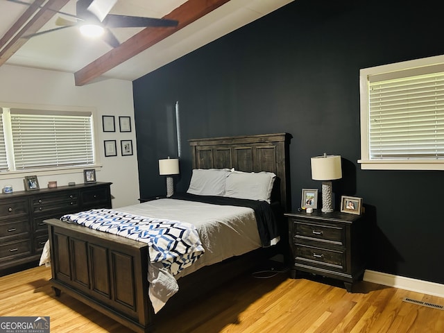 bedroom featuring beamed ceiling, ceiling fan, and light hardwood / wood-style floors