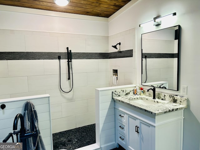 bathroom featuring vanity, wooden ceiling, and tiled shower