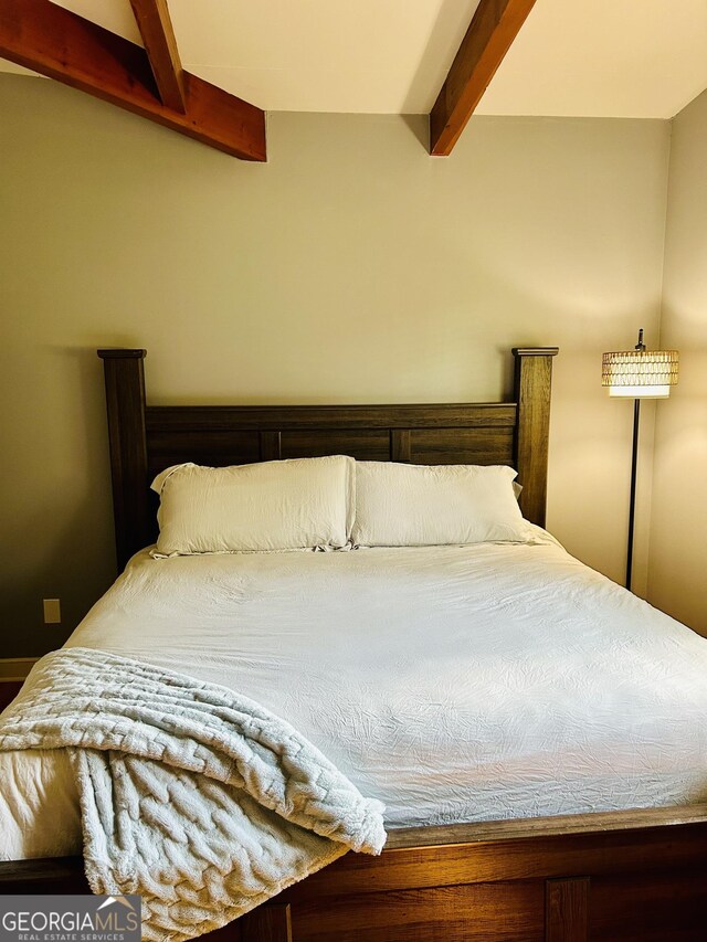 bedroom with beam ceiling