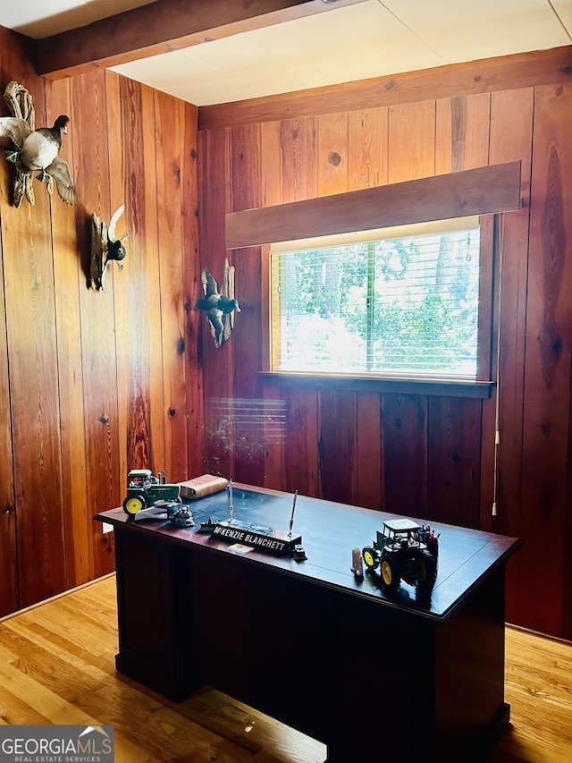 office with wood walls, beamed ceiling, and hardwood / wood-style flooring