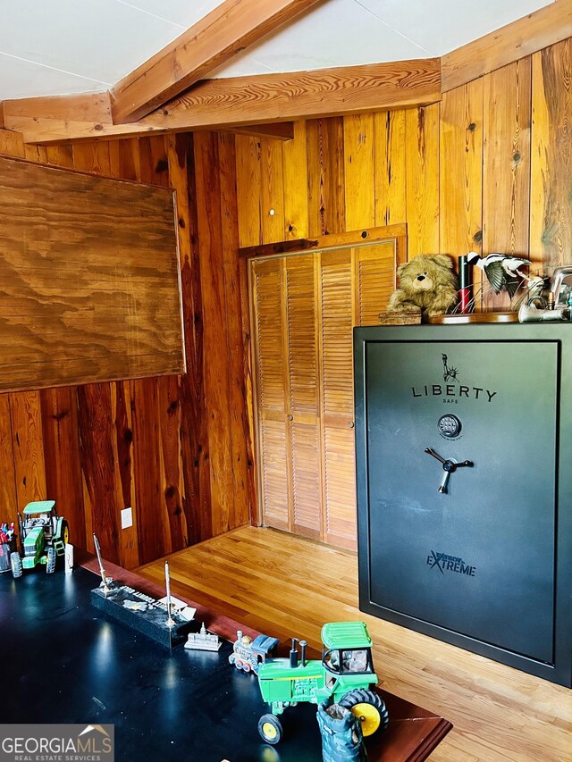 interior space featuring light hardwood / wood-style floors and wood walls