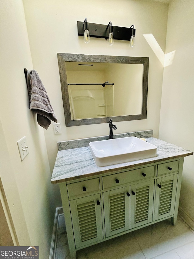 bathroom with tile floors and vanity