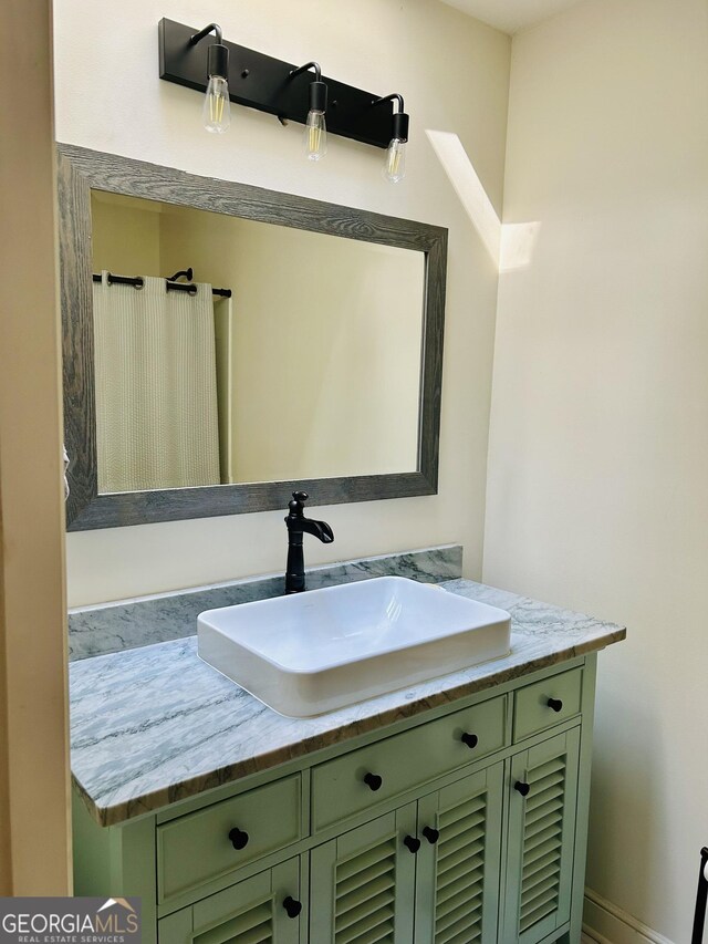 bathroom featuring vanity with extensive cabinet space