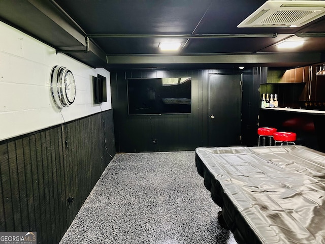 bedroom with wood walls and pool table