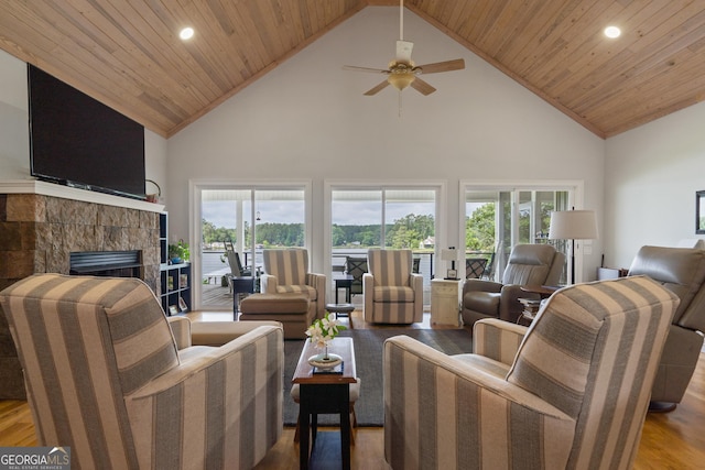 living room with high vaulted ceiling, hardwood / wood-style floors, a wealth of natural light, and wood ceiling