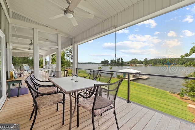 wooden deck with ceiling fan and a water view