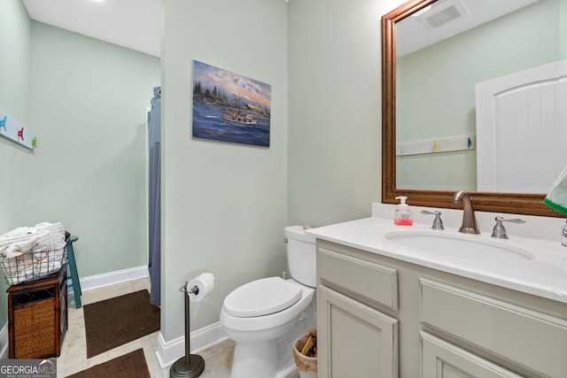 bathroom featuring tile patterned floors, vanity, and toilet