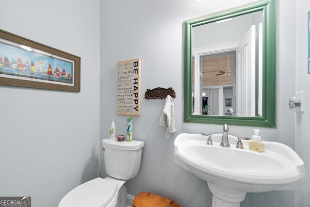 bathroom with ceiling fan, sink, and toilet