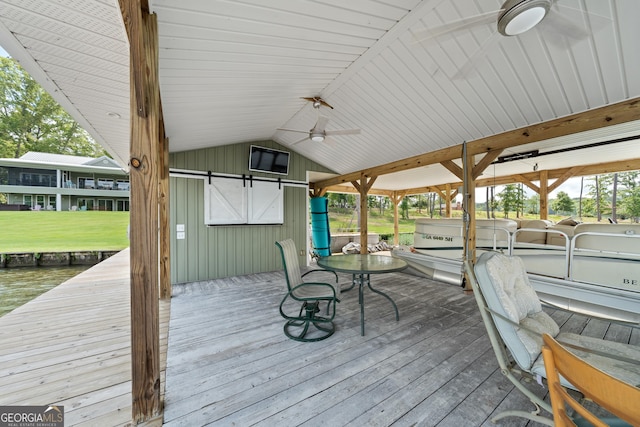 wooden terrace with ceiling fan and a boat dock