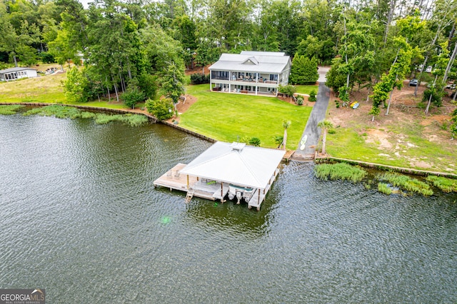 view of dock featuring a water view and a yard