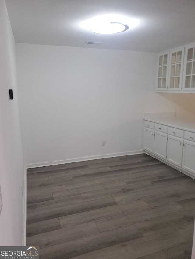 empty room with dark hardwood / wood-style floors