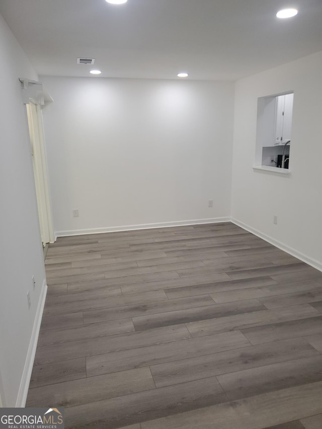 basement with hardwood / wood-style flooring