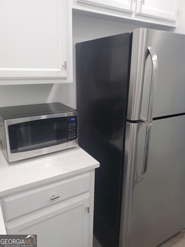 kitchen featuring white cabinets and appliances with stainless steel finishes