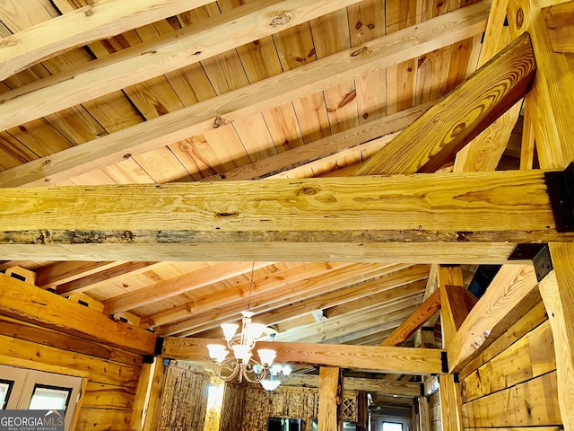 details featuring beam ceiling and an inviting chandelier