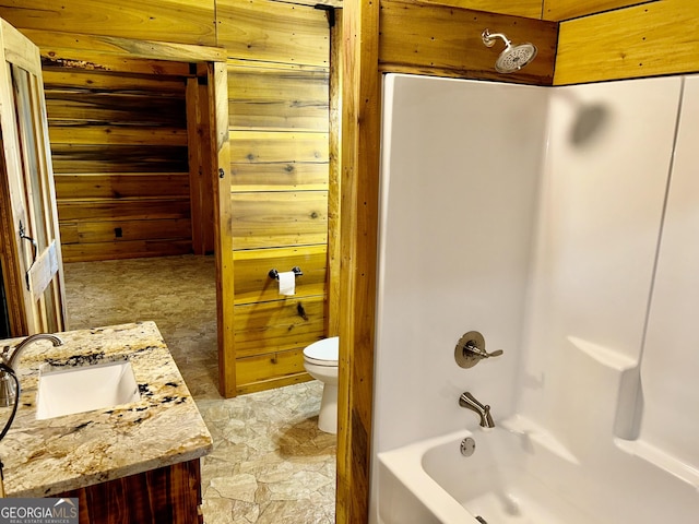 full bathroom with shower / tub combination, vanity, toilet, and wooden walls