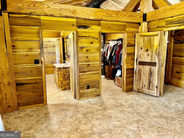 bedroom featuring wood walls and a closet