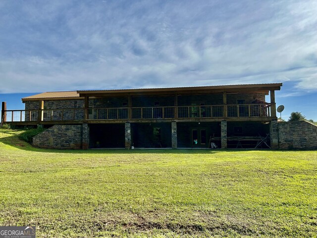 back of house with a lawn, central AC unit, and a deck