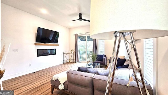 living room featuring hardwood / wood-style flooring and ceiling fan