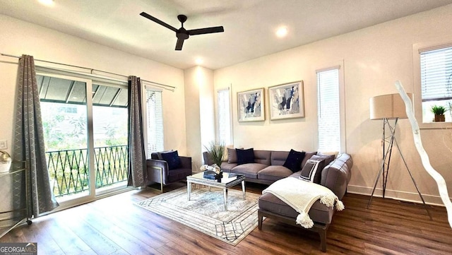 living room with ceiling fan, plenty of natural light, and wood-type flooring