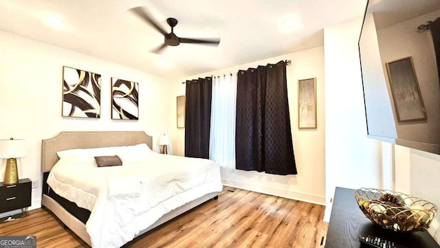 bedroom featuring ceiling fan and light hardwood / wood-style flooring