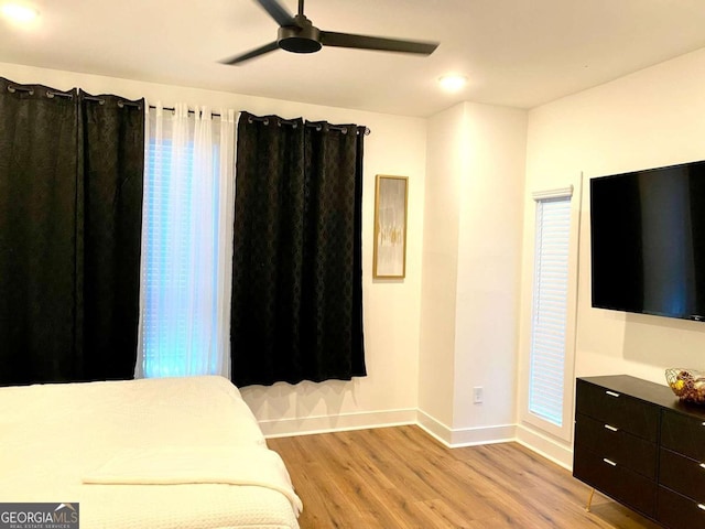 bedroom with light hardwood / wood-style floors and ceiling fan