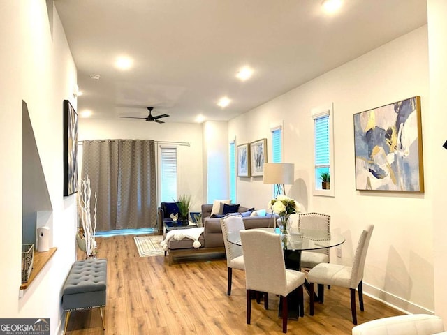 dining room featuring ceiling fan, light hardwood / wood-style floors, and radiator heating unit