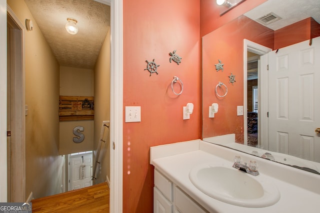 bathroom with vanity and a textured ceiling