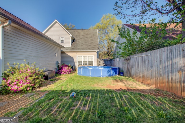 view of yard with a fenced in pool