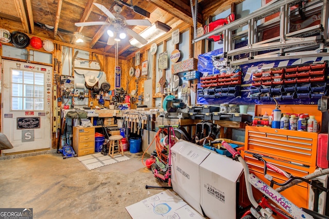 miscellaneous room with a workshop area, ceiling fan, and concrete flooring