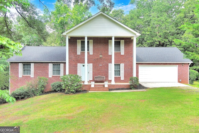 view of front facade with a front yard and a garage