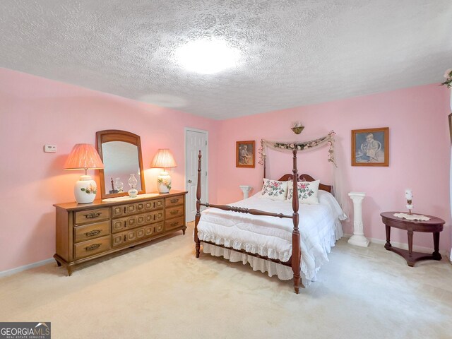 carpeted bedroom featuring a textured ceiling