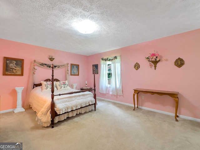 bedroom featuring light carpet, ornate columns, and a textured ceiling