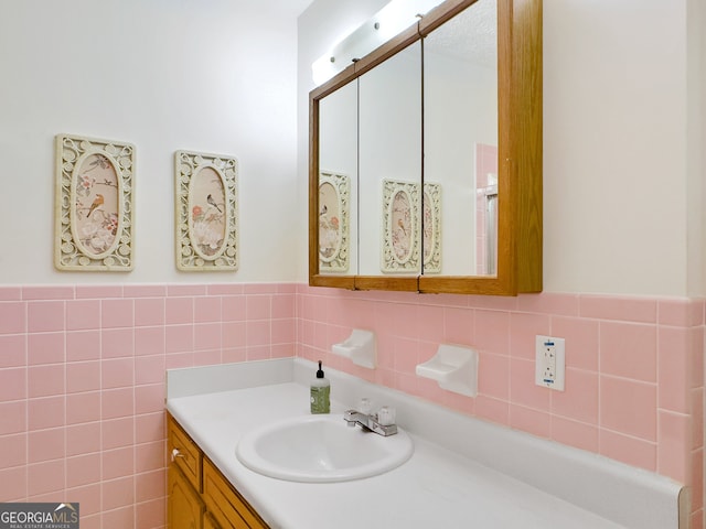 bathroom featuring vanity, decorative backsplash, and tile walls