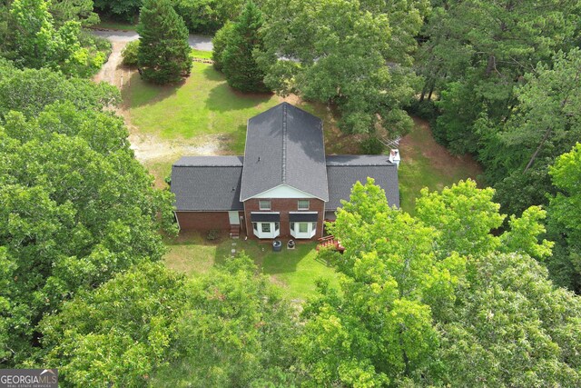 greek revival house featuring a garage and a front yard