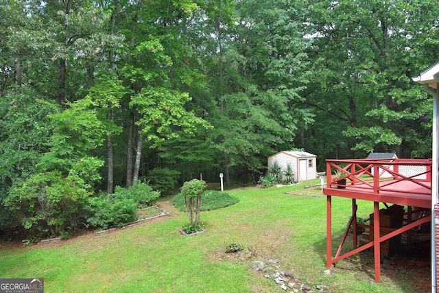 view of yard with a storage shed and a deck