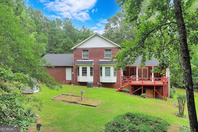 rear view of property with central AC, a lawn, and a wooden deck