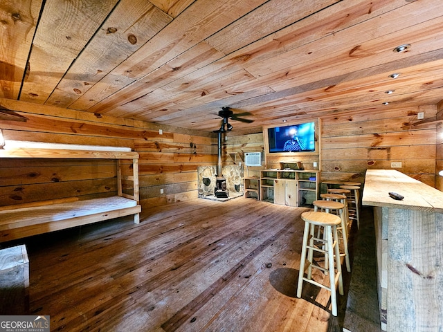 unfurnished bedroom featuring wooden ceiling, wood walls, and hardwood / wood-style floors