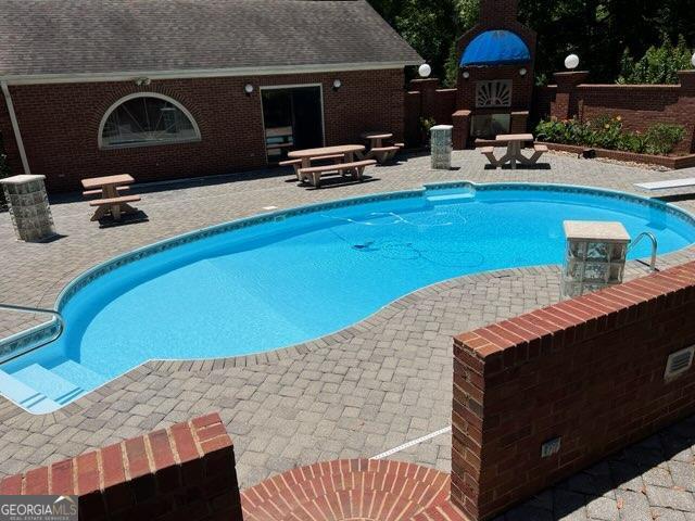 view of swimming pool with a patio