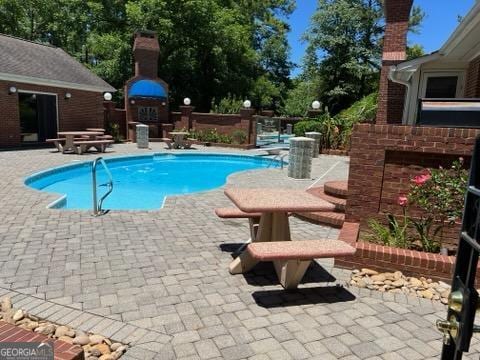 view of swimming pool featuring a patio