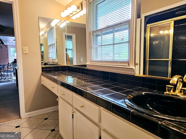 bathroom with tile flooring and vanity