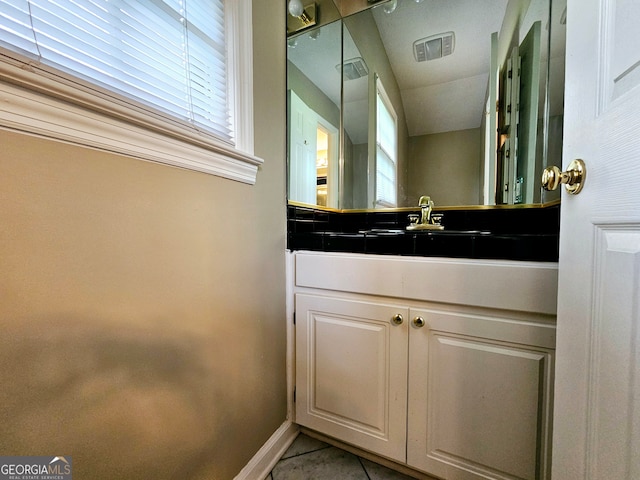 bathroom featuring tile flooring and vanity