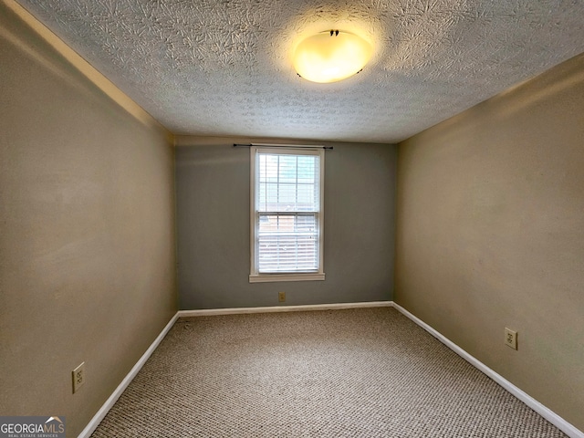 unfurnished room with a textured ceiling and carpet