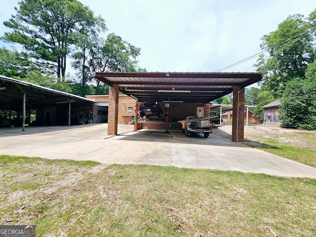 view of parking / parking lot featuring a carport and a lawn