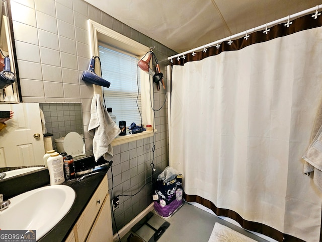 bathroom with tile walls and vanity