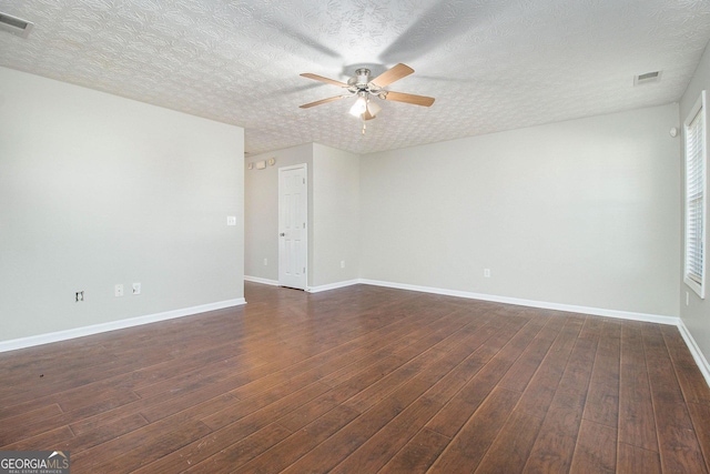 spare room with ceiling fan, dark hardwood / wood-style flooring, and a textured ceiling