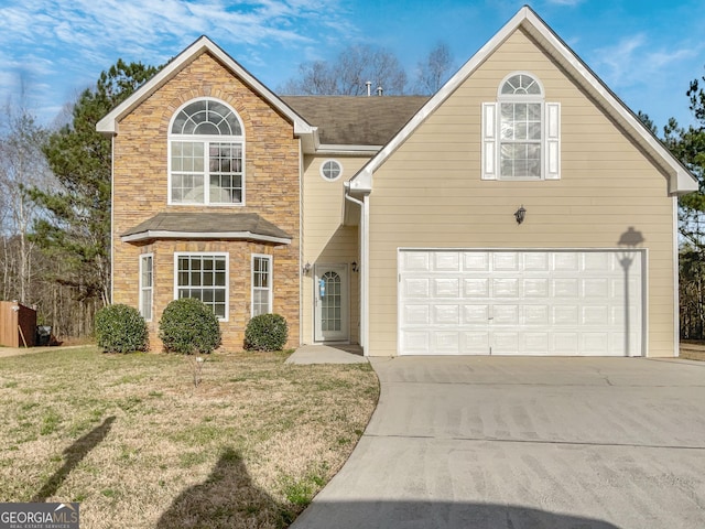 view of property featuring a front yard and a garage